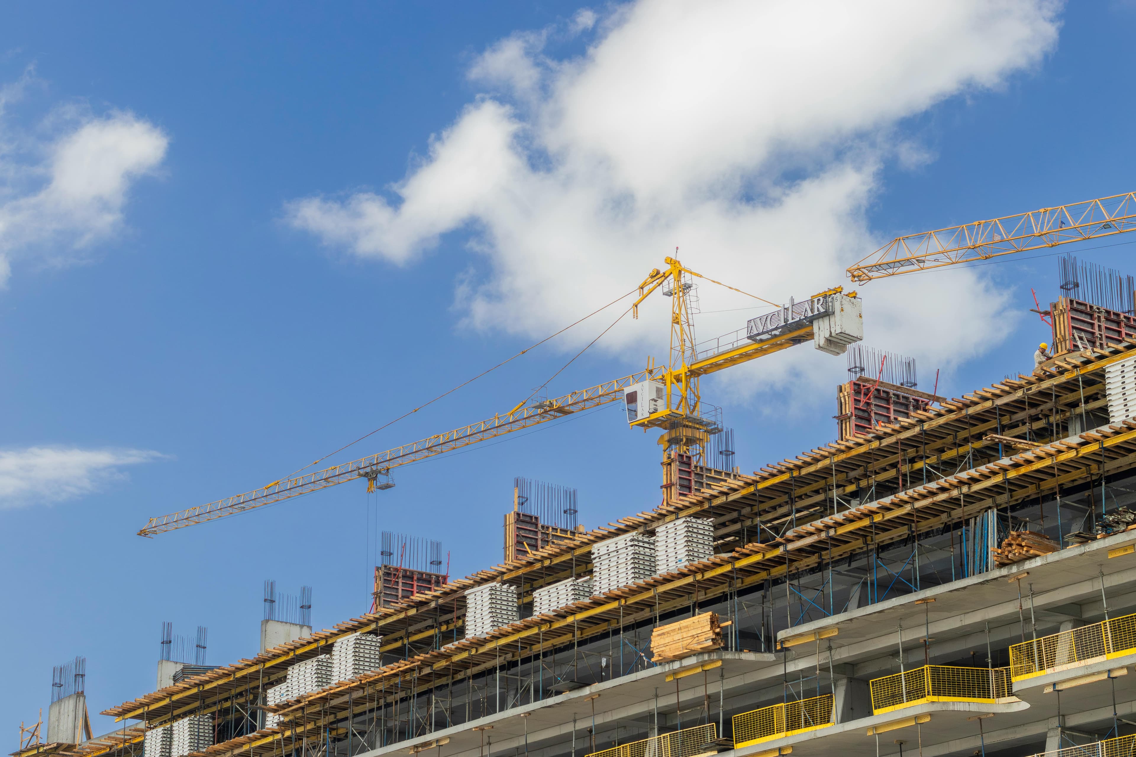 Large construction site with cranes and concrete frame